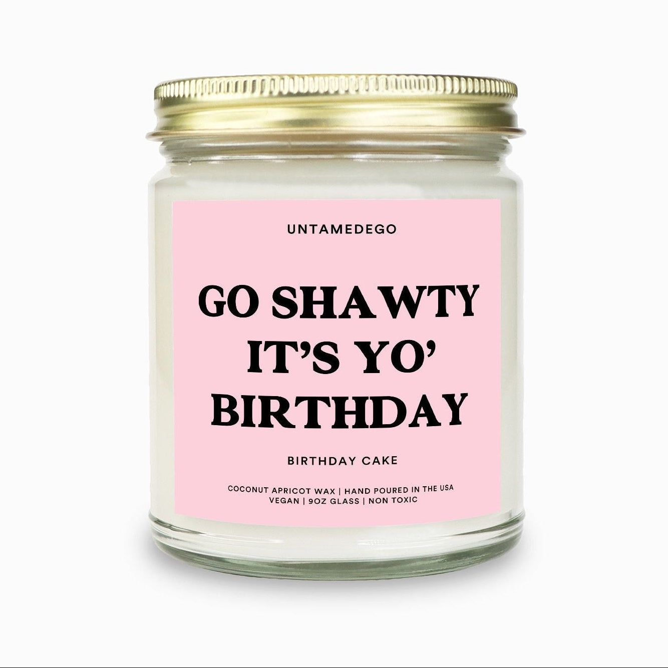 Candle with pink label and gold lid on a white background