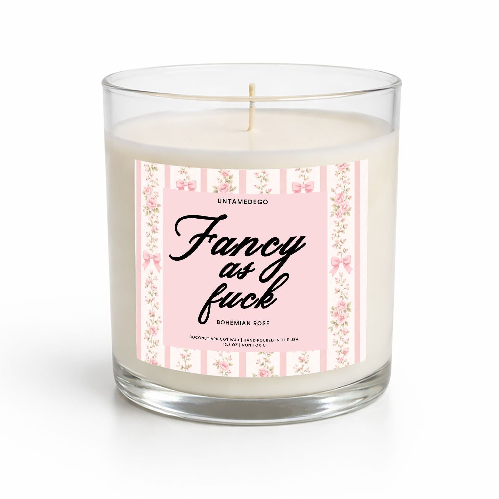Candle with a pink label featuring text on a white background