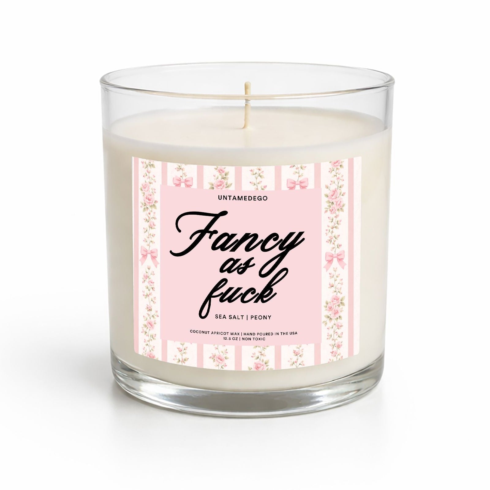 Candle with a pink label featuring text on a white background