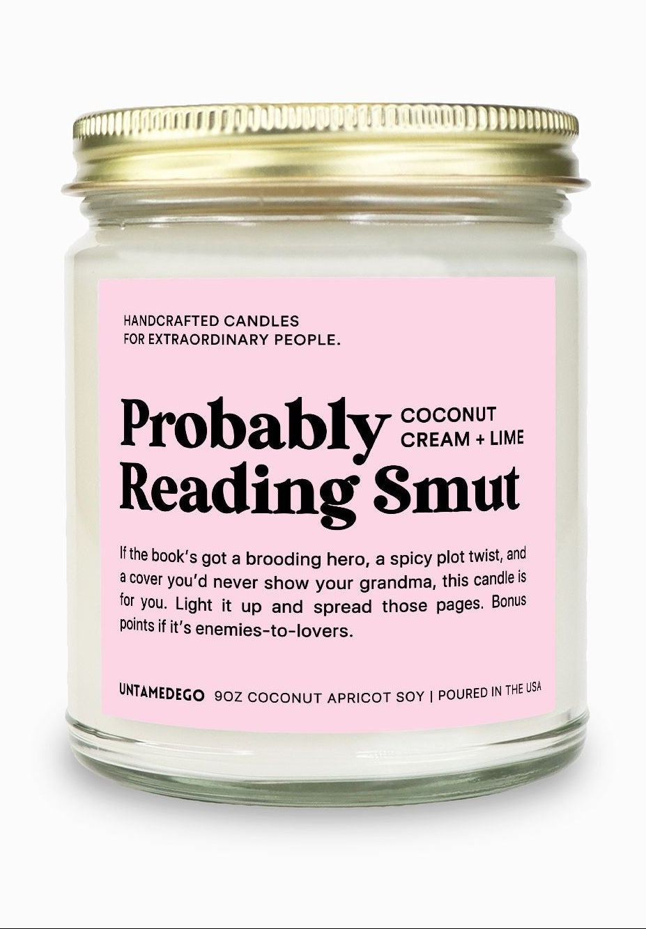 Candle jar with pink label on a white background