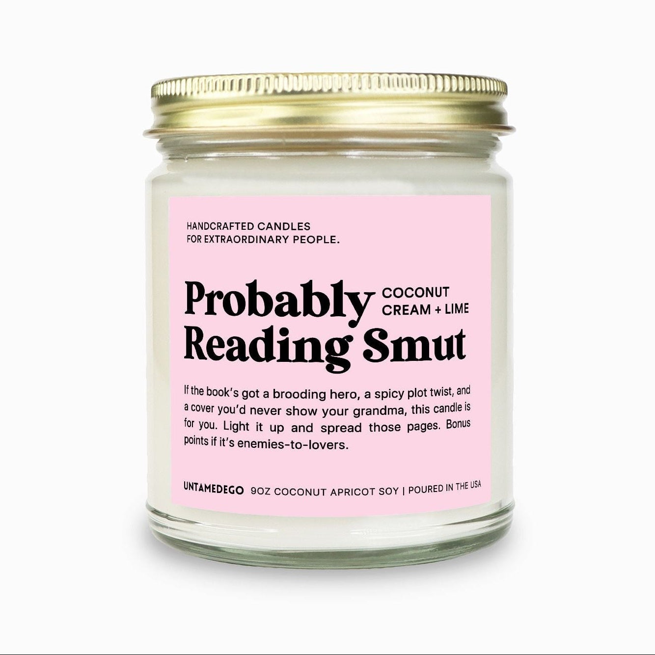 Candle jar with pink label on a white background