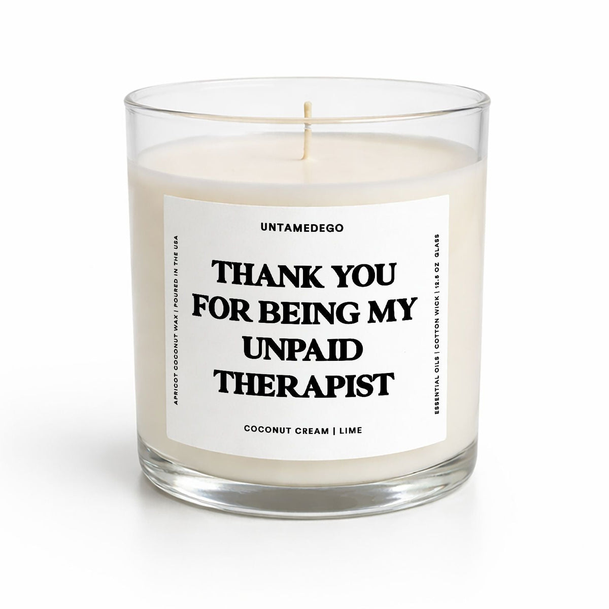 Candle in a glass jar with a label on a white background