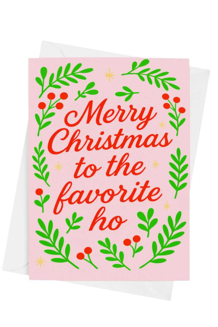 Christmas card with red text and green leaves on a pink background