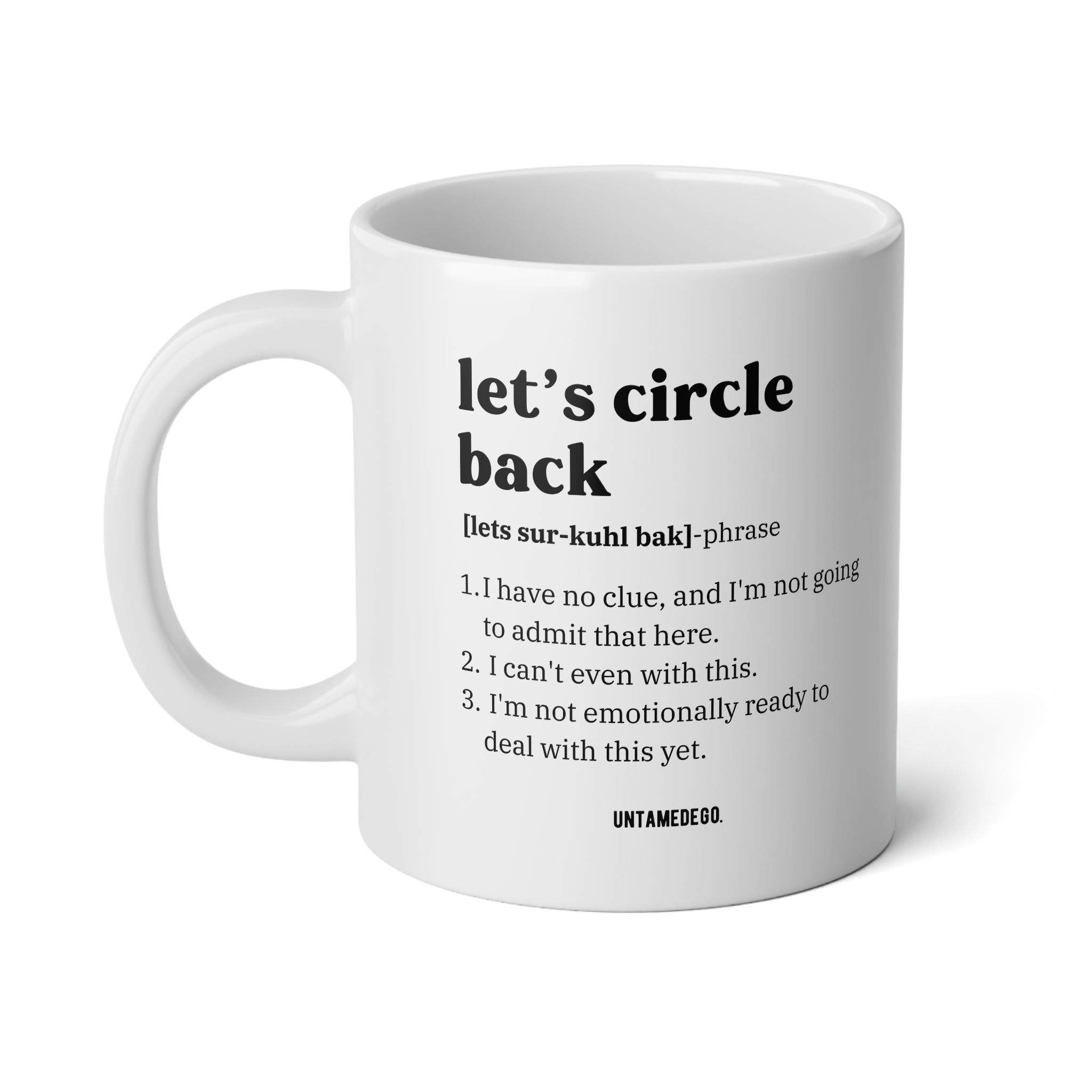 A white ceramic coffee mug with black printed text on a clean white background. The text reads 'let's circle back' followed by a pronunciation guide and a humorous definition, with the brand name 'UNTAMED.