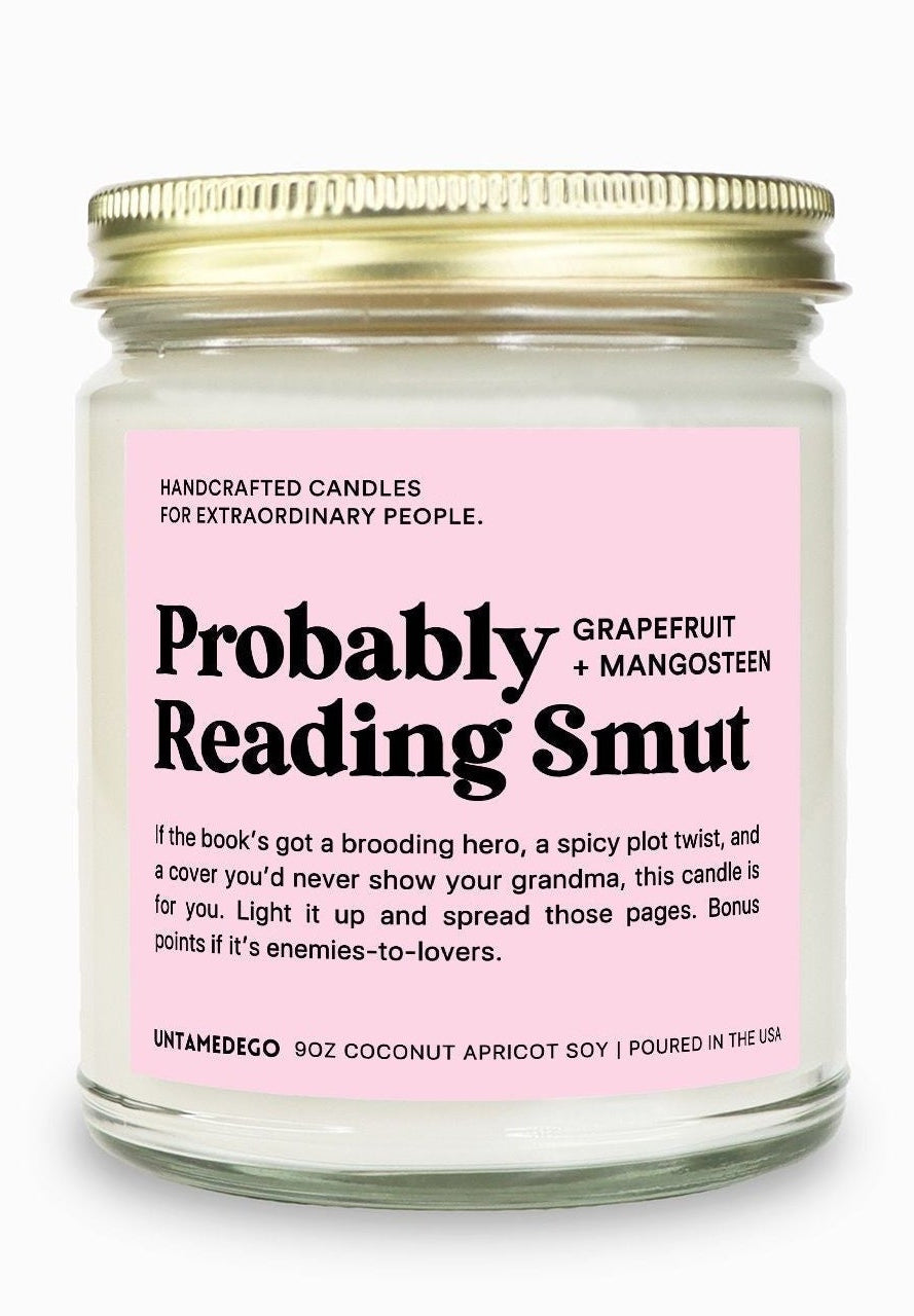 Candle jar with pink label on a white background