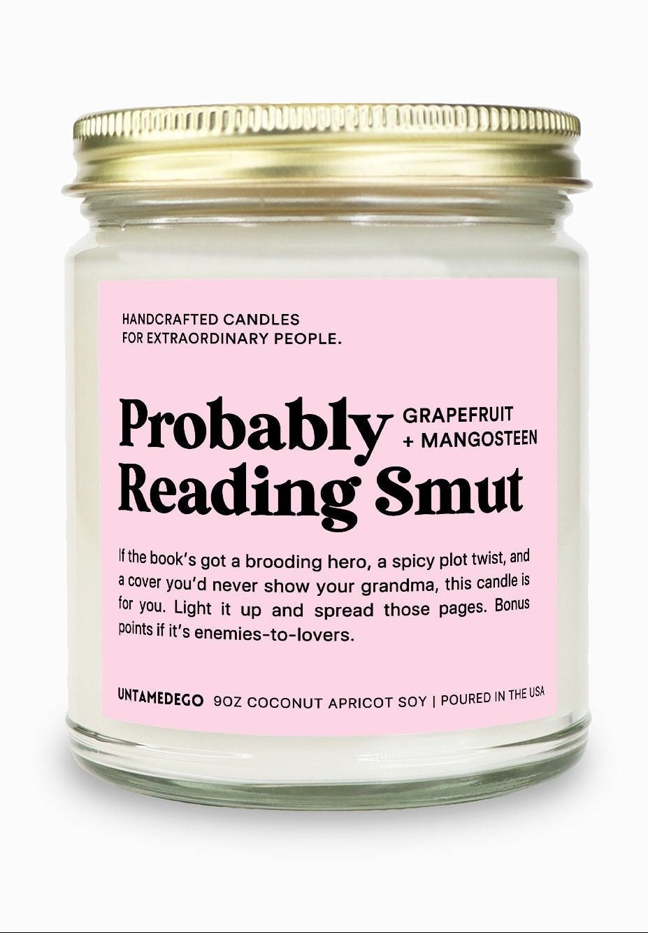 Candle jar with pink label on a white background