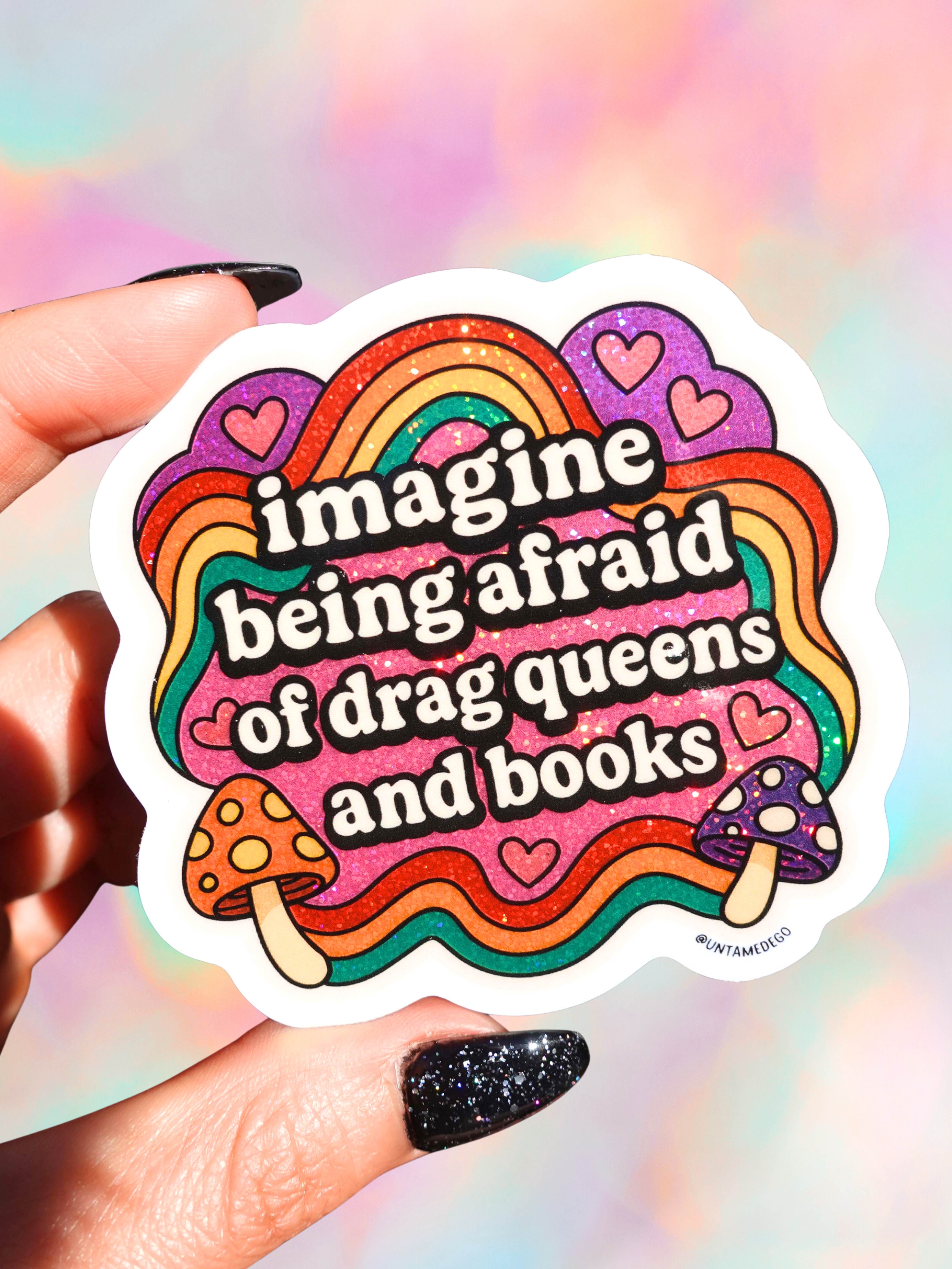 Sticker with rainbow design and text held by a hand against a colorful background