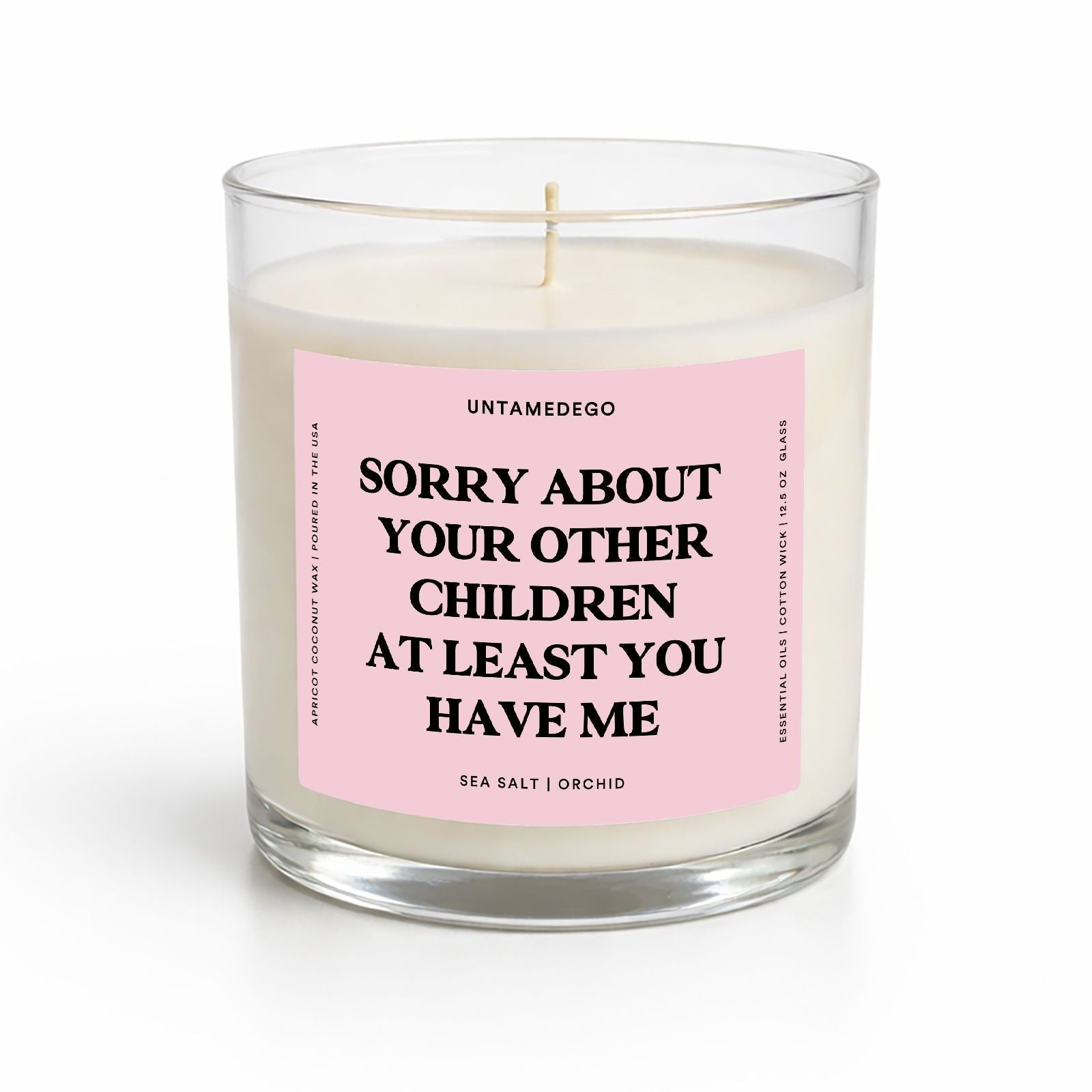 Candle with a pink label and text on a white background