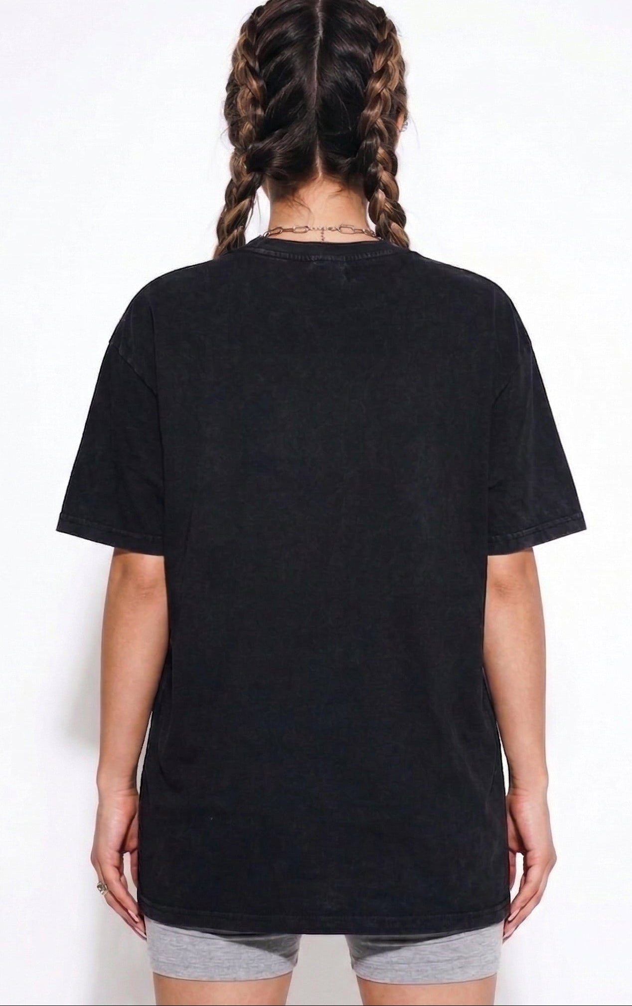 Person wearing a black t-shirt on a white background
