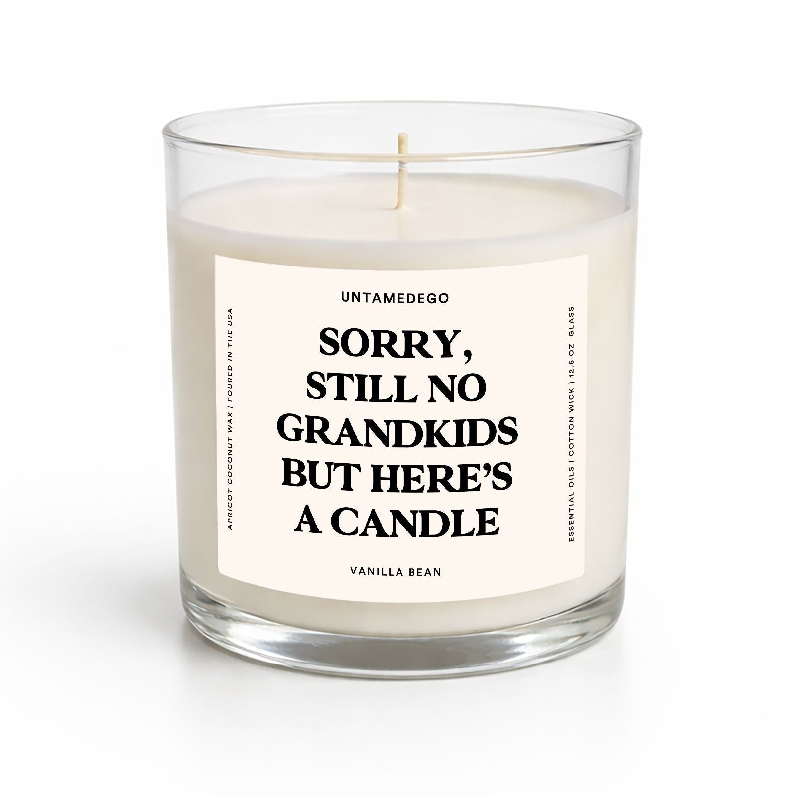 Candle in a glass jar with a label on a white background