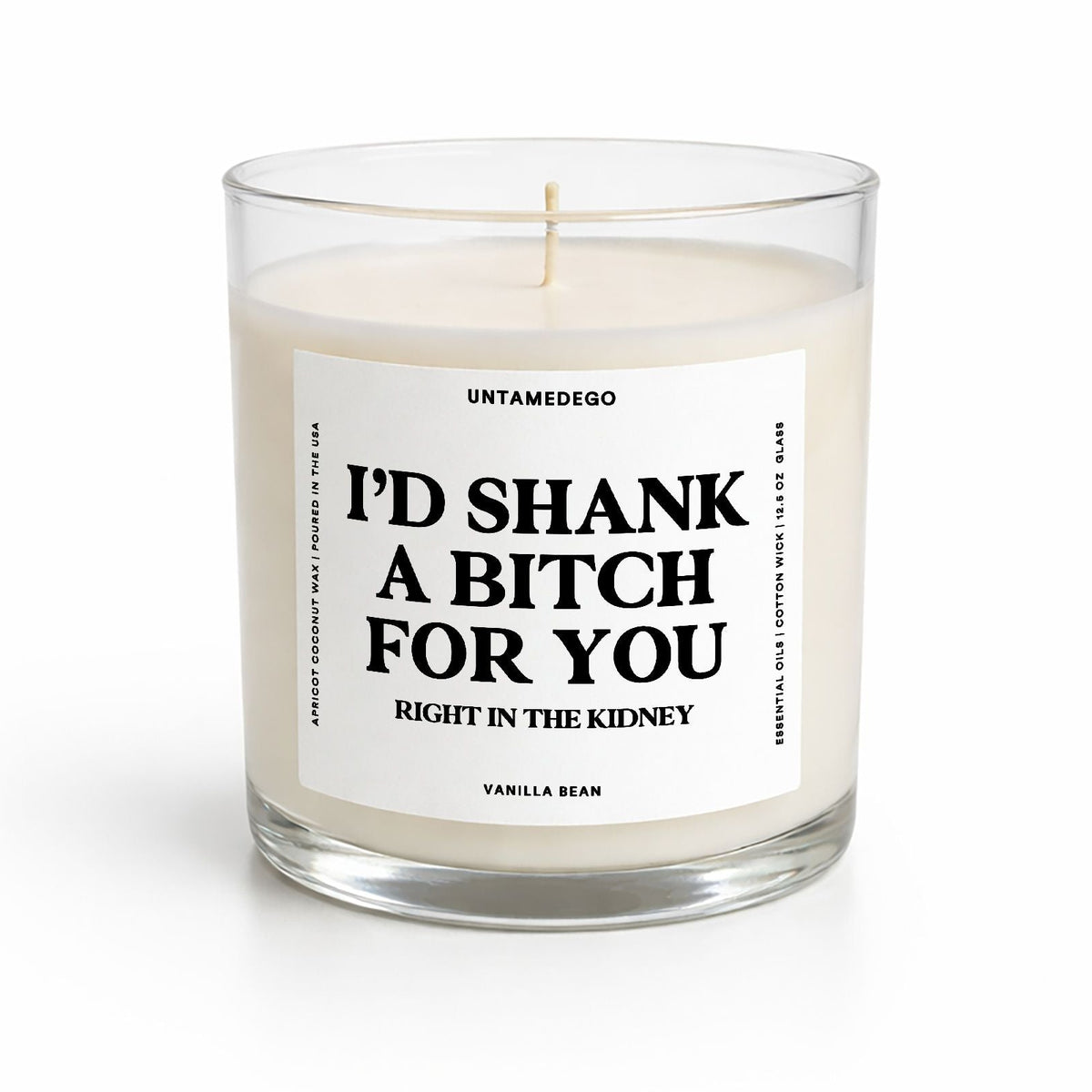 A wax candle in a clear glass jar with a white label that reads 'I'D SHANK A BITCH FOR YOU RIGHT IN THE KIDNEY' and 'VANILLA BEAN' at the bottom, on a white background.
