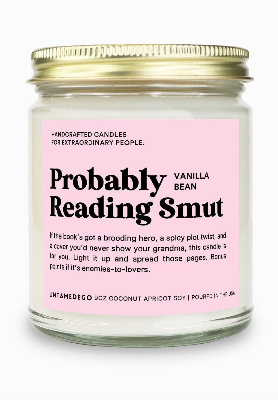 Candle jar with pink label and gold lid on a white background