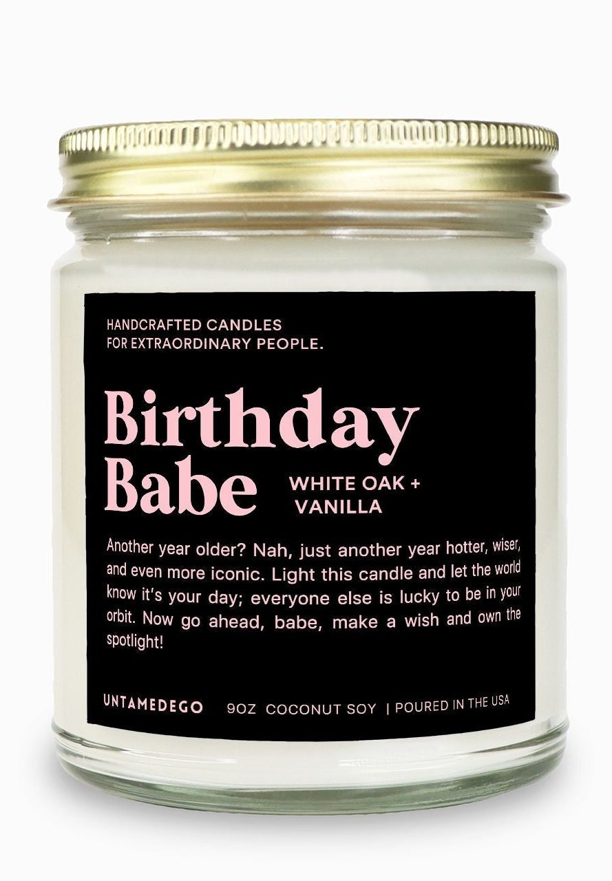Candle jar labeled 'Birthday Babe' with a gold lid on a white background