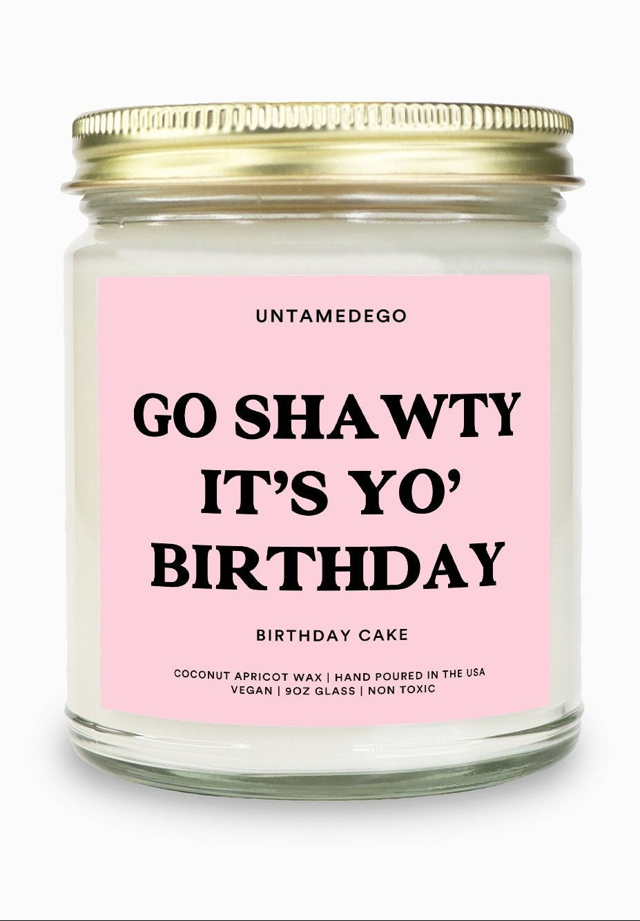 Candle with pink label and gold lid on a white background