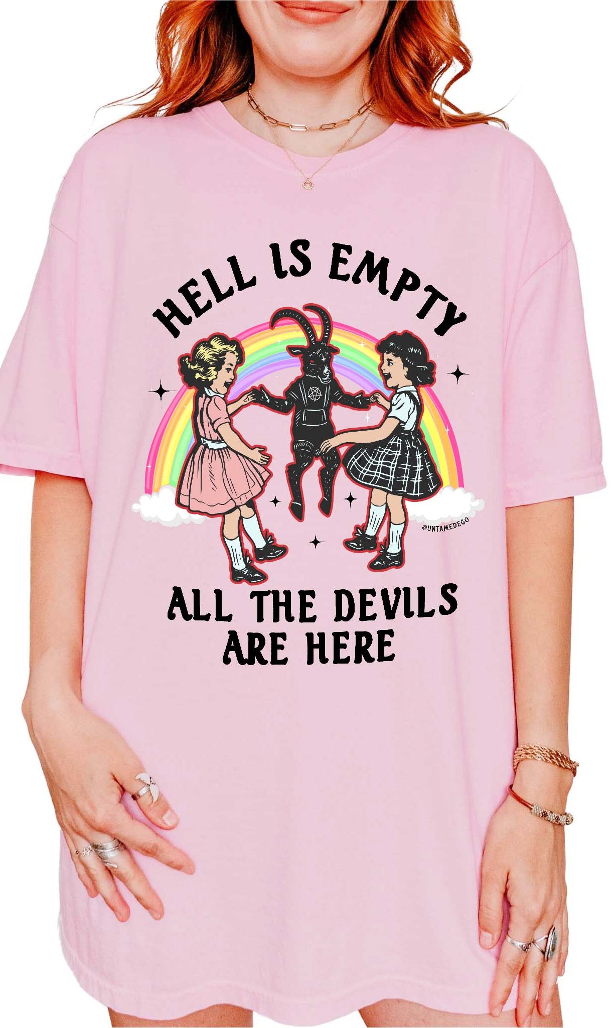 Person wearing a pink t-shirt with a graphic design and text.