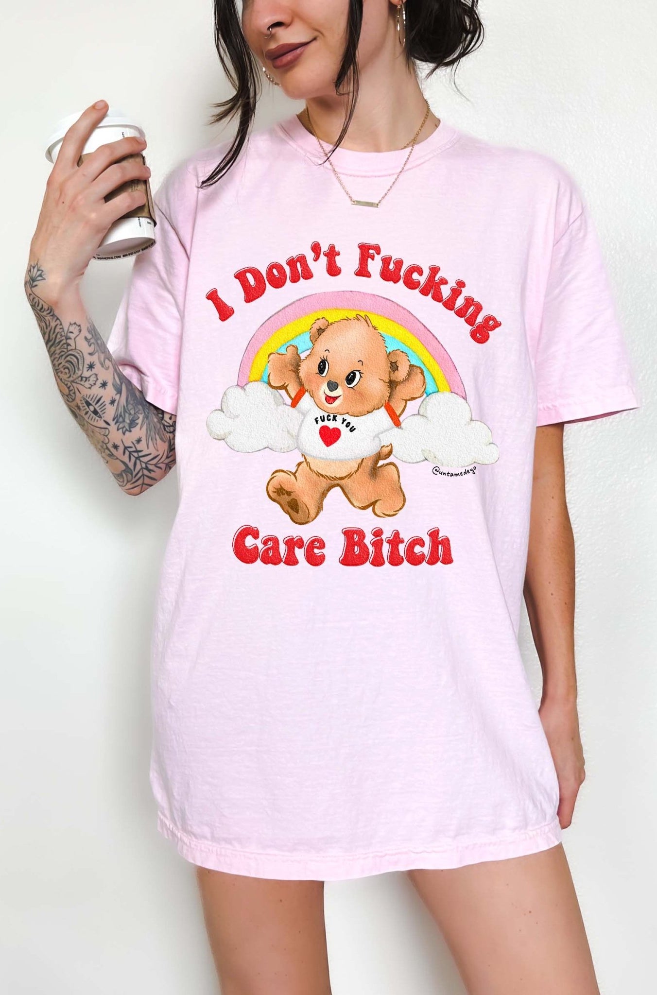 Funny graphic t-shirt with cute bear and rainbow design and bold text expressing not caring attitude