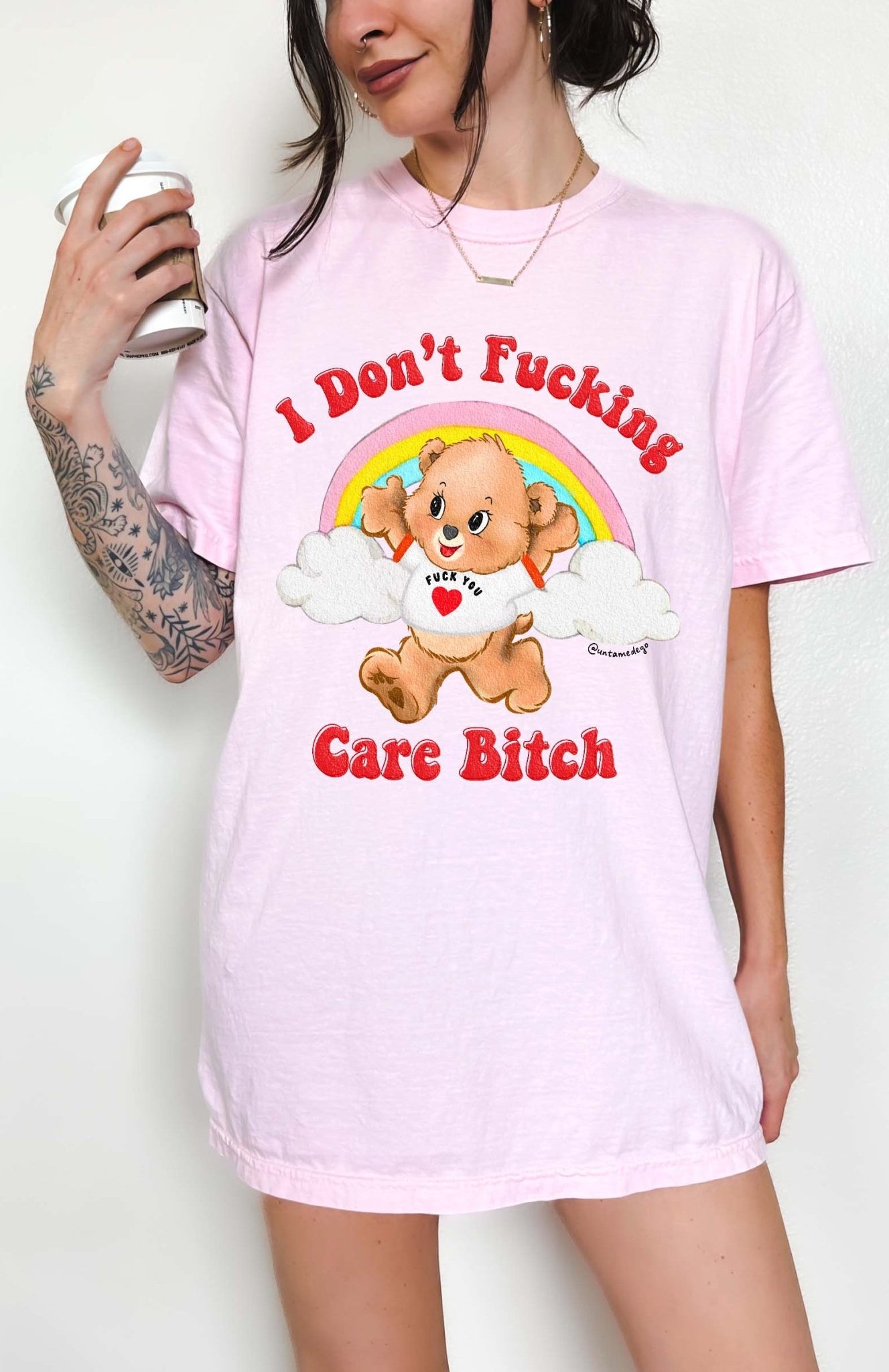 Funny graphic t-shirt with cute bear and rainbow design and bold text expressing not caring attitude