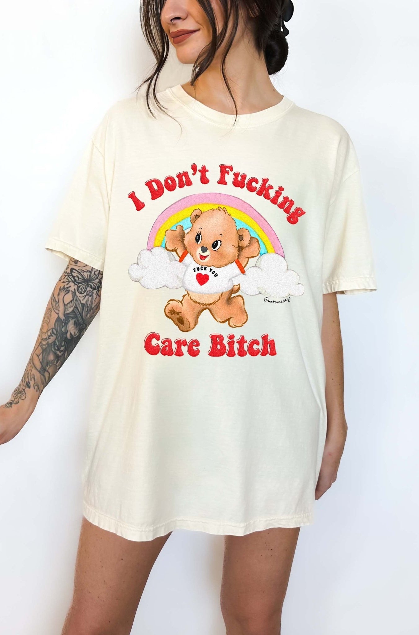 Funny graphic t-shirt with cute bear and rainbow design and bold text expressing not caring attitude