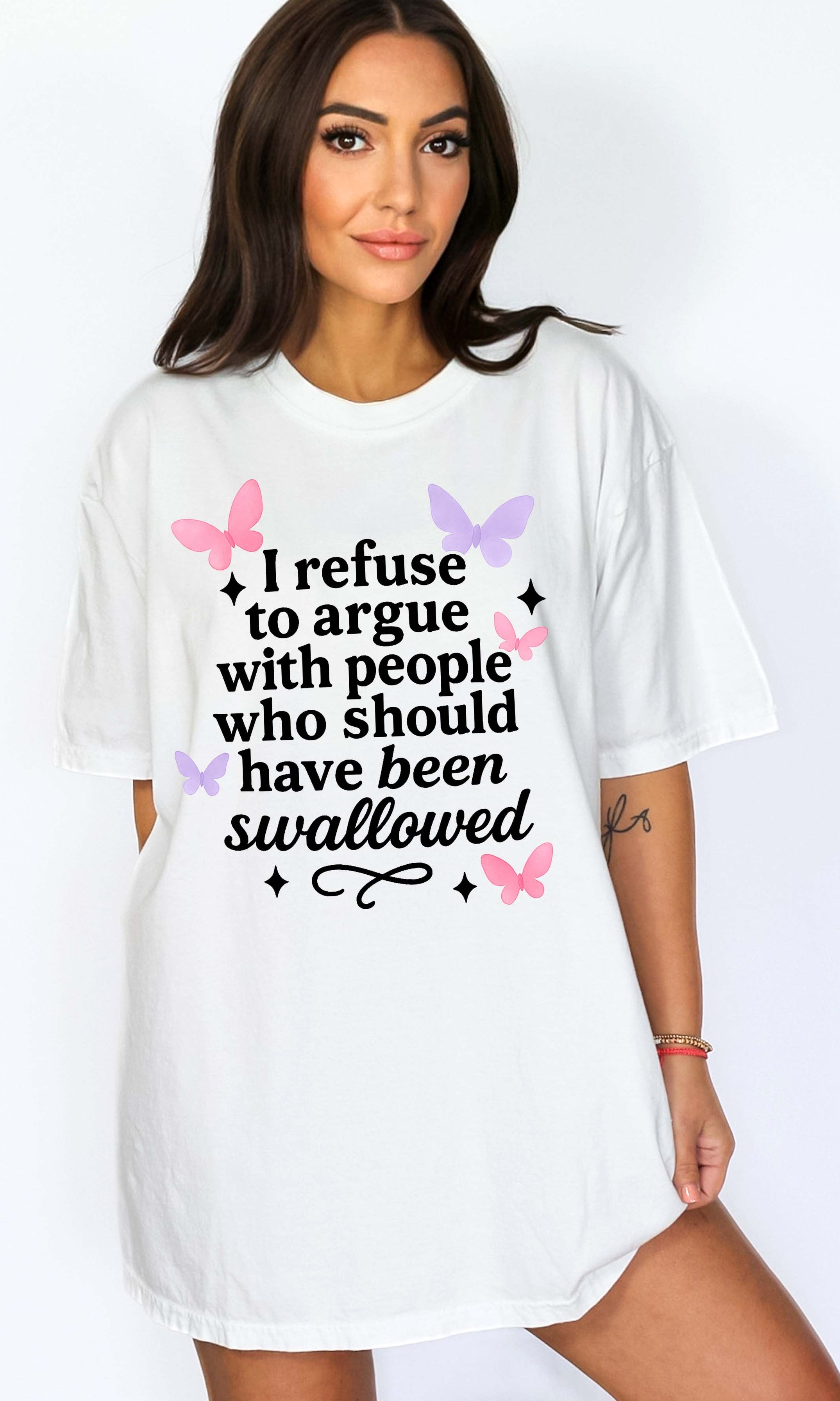 Woman wearing a white t-shirt with a humorous text design on a plain background