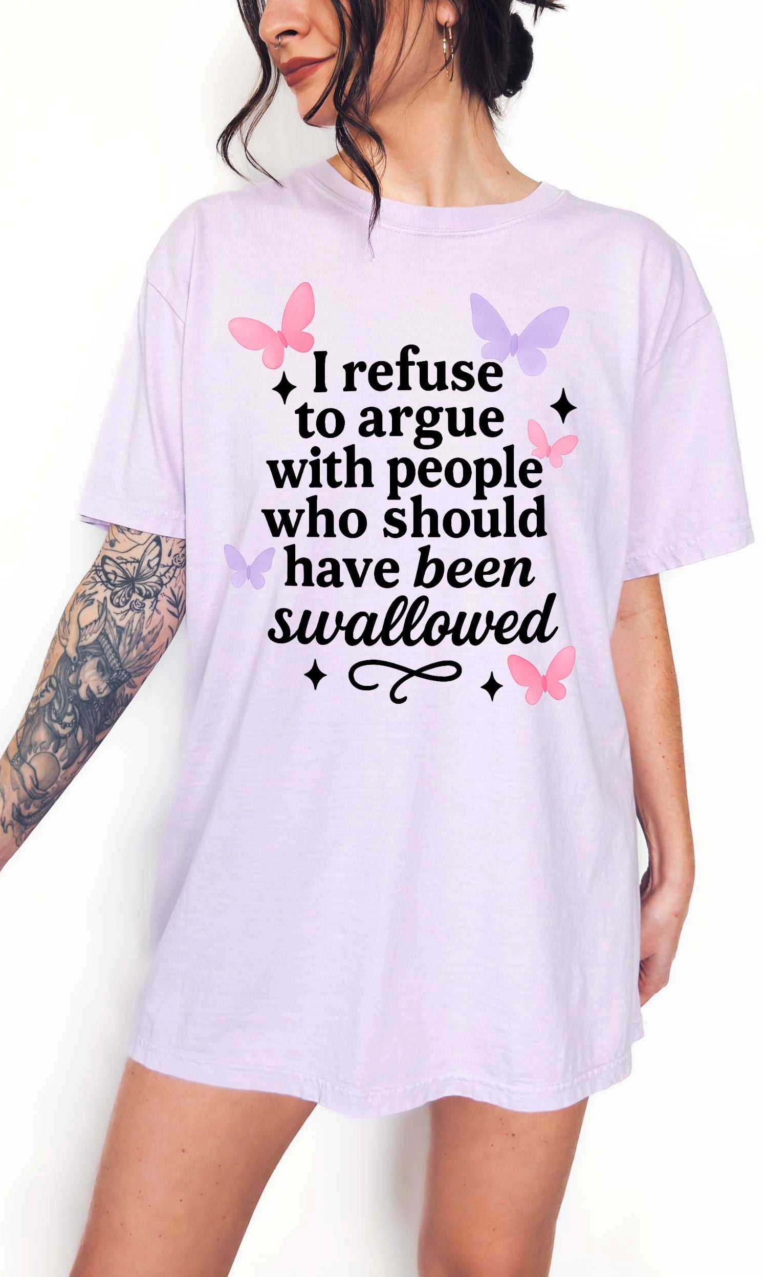 Person wearing a white t-shirt with a humorous text design on a plain background