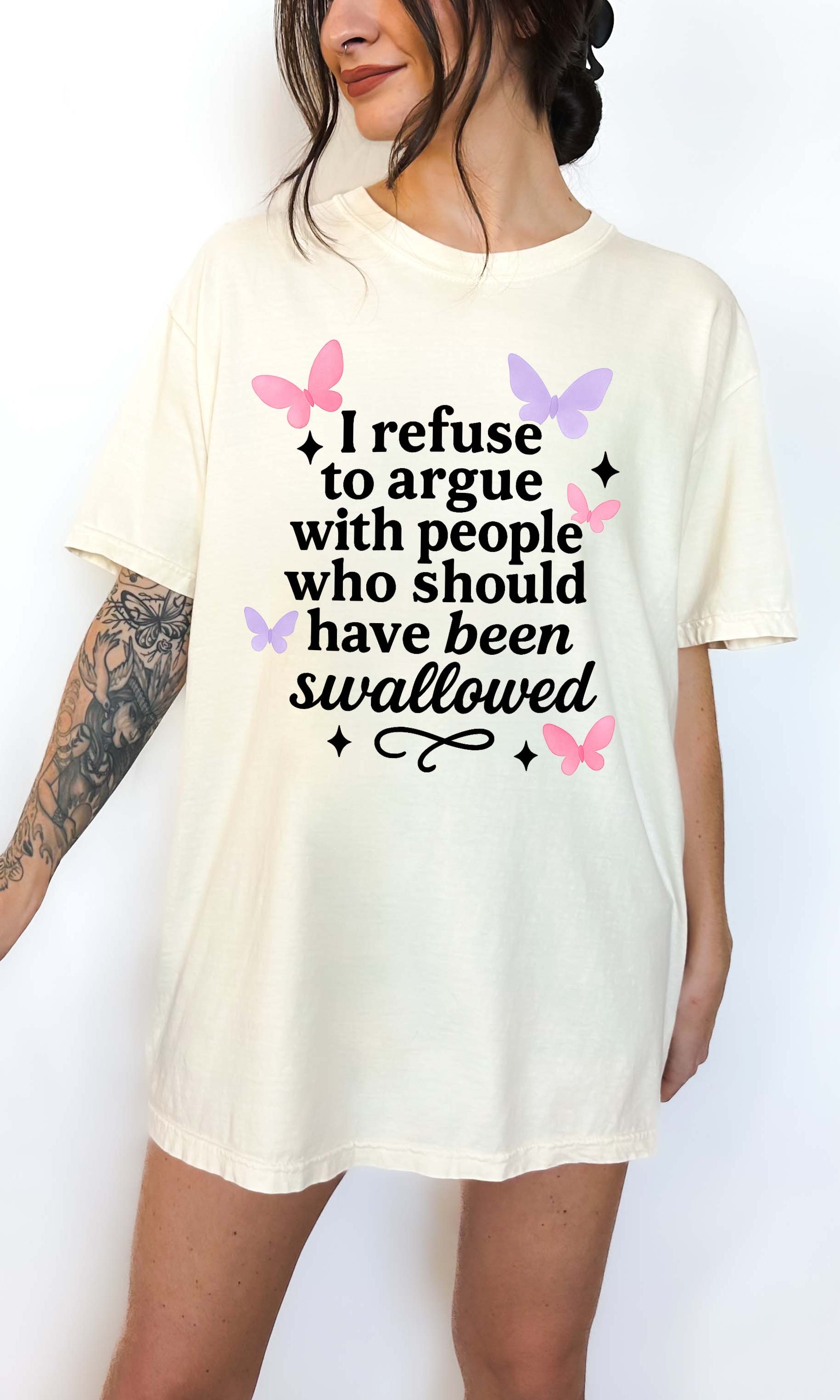 Person wearing a white t-shirt with a humorous text design on a plain background