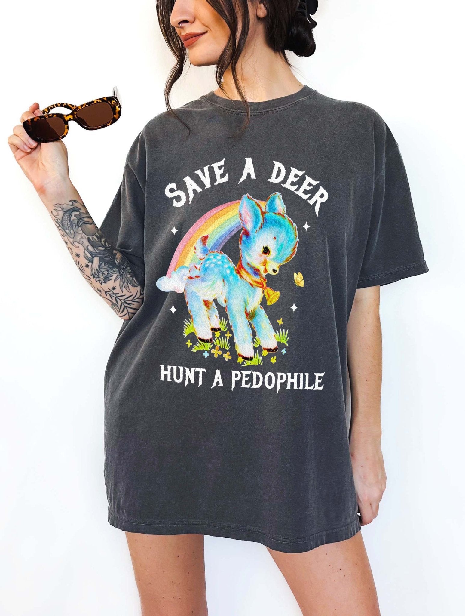 Vintage style deer graphic t-shirt with rainbow design and bold statement text, worn oversized on a model