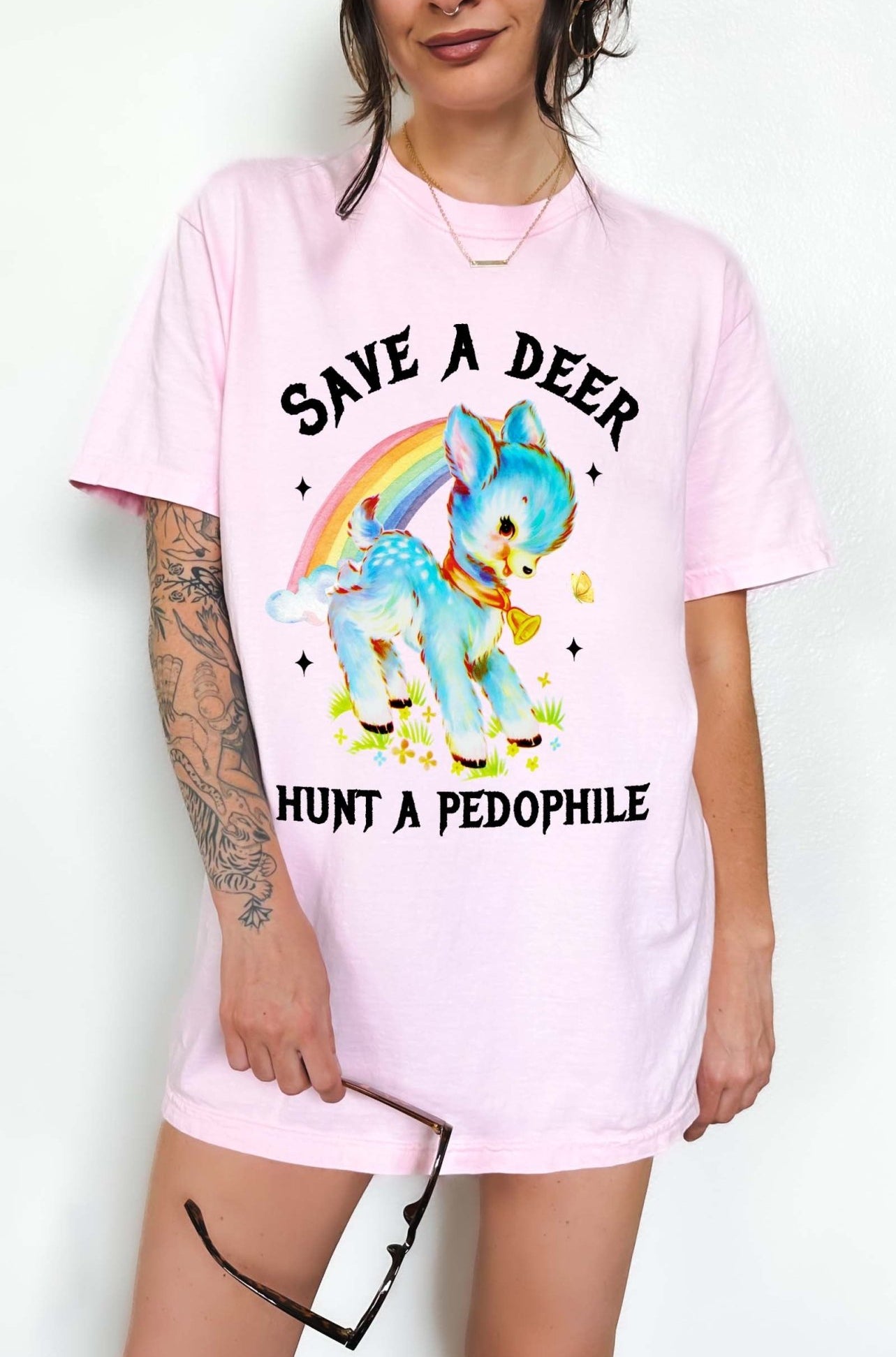 Vintage style deer graphic t-shirt with rainbow design and bold statement text, worn oversized on a model