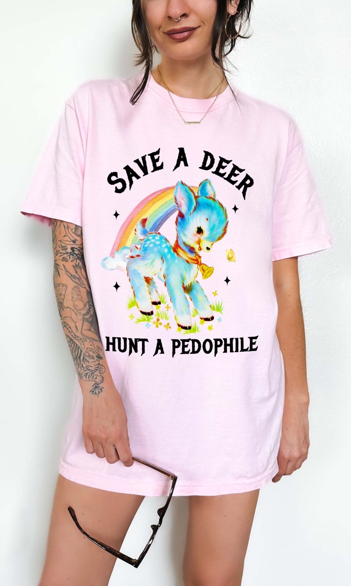 Vintage style deer graphic t-shirt with rainbow design and bold statement text, worn oversized on a model