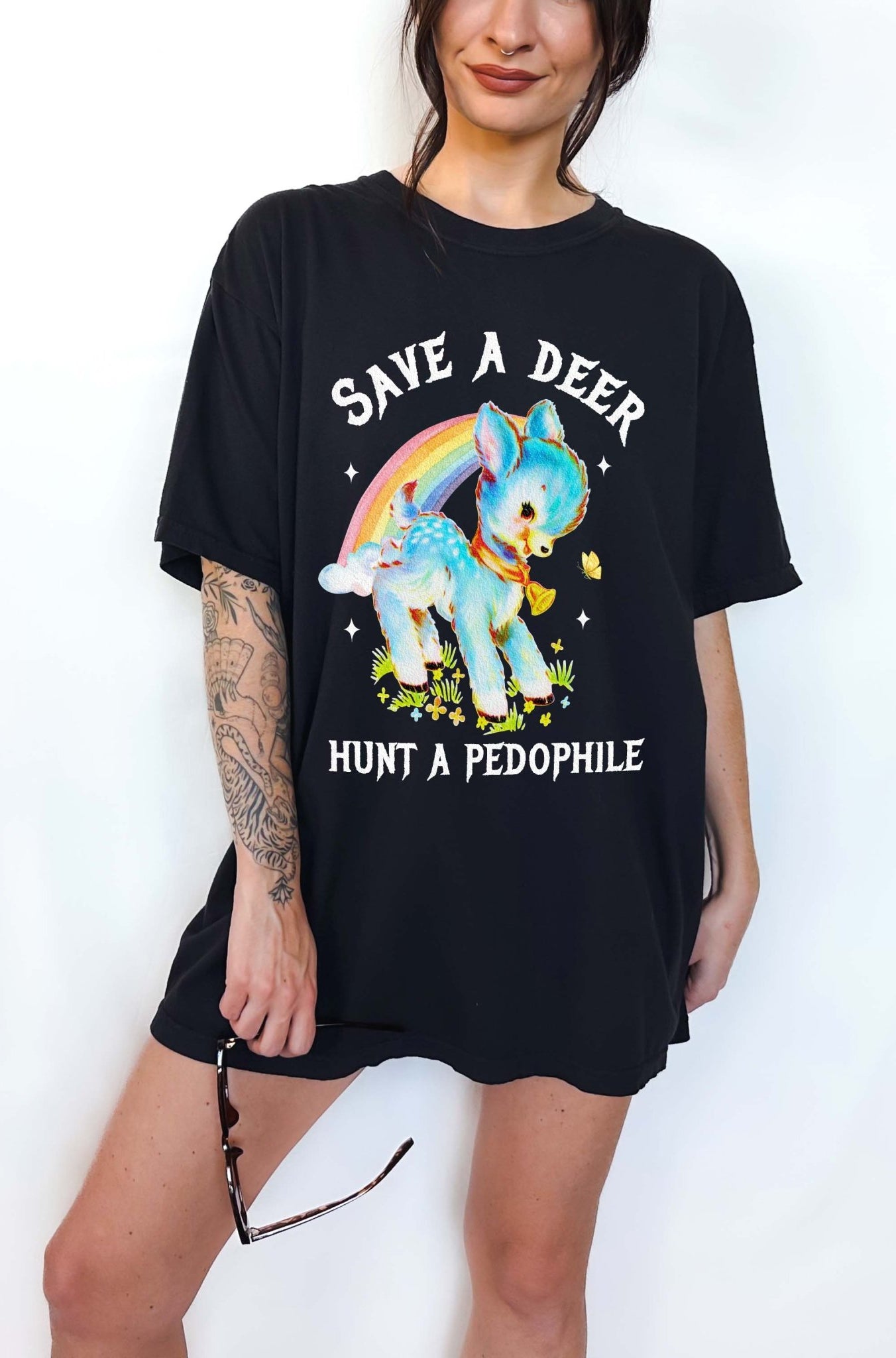 Vintage style deer graphic t-shirt with rainbow design and bold statement text, worn oversized on a model