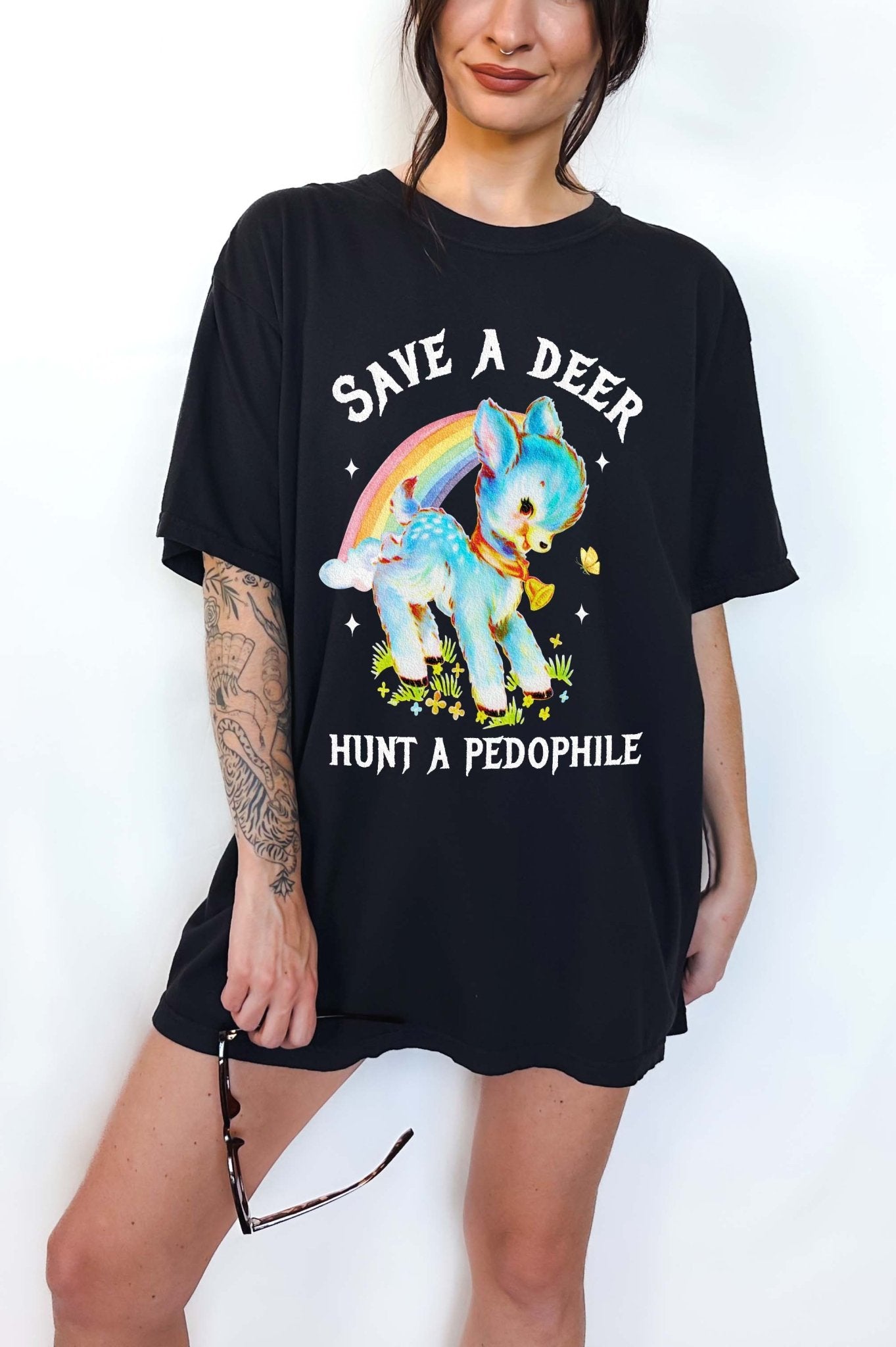 Vintage style deer graphic t-shirt with rainbow design and bold statement text, worn oversized on a model