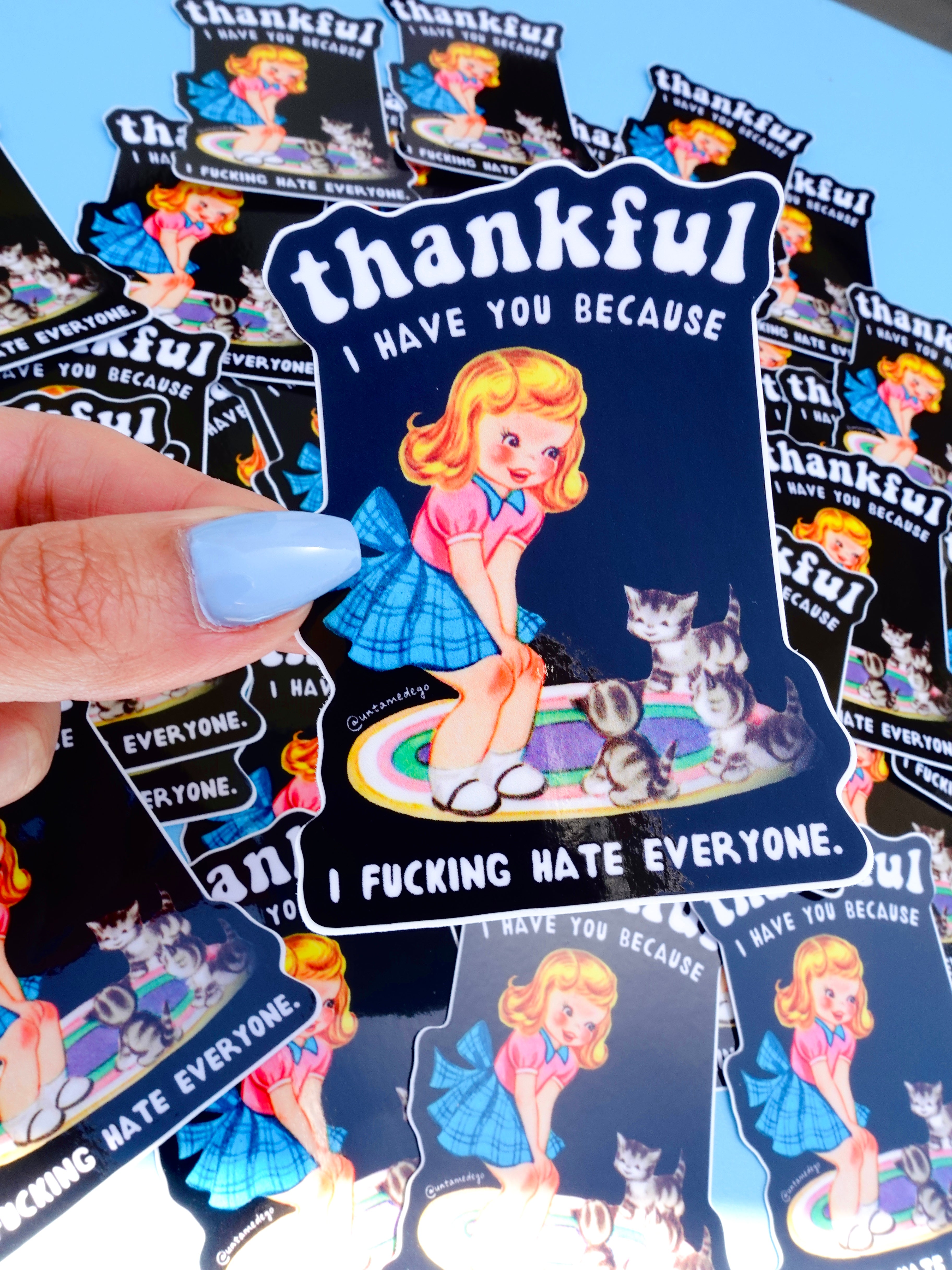 Funny vinyl sticker with retro-style girl and kittens on a rug. Text reads “Thankful I Have You Because I F*cking Hate Everyone.”