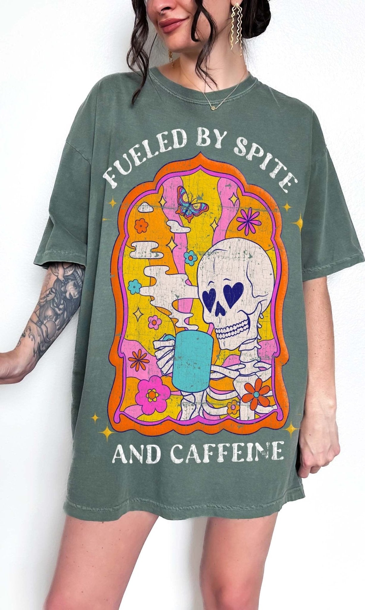 Funny coffee t-shirt with skeleton drinking coffee and text saying fueled by spite and caffeine