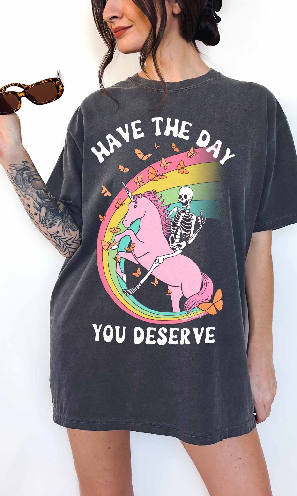 Funny sarcastic t-shirt with unicorn and skeleton design and text saying have the day you deserve