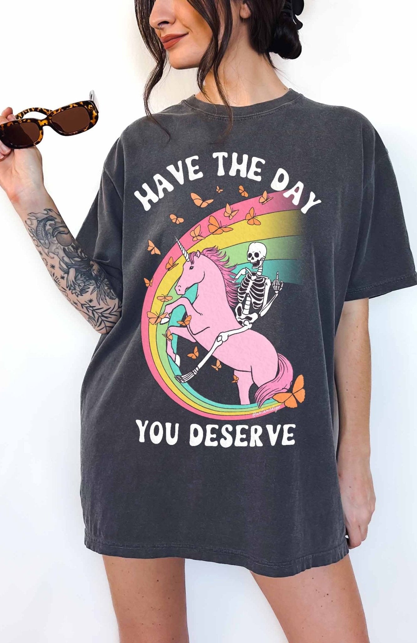 Funny sarcastic t-shirt with unicorn and skeleton design and text saying have the day you deserve