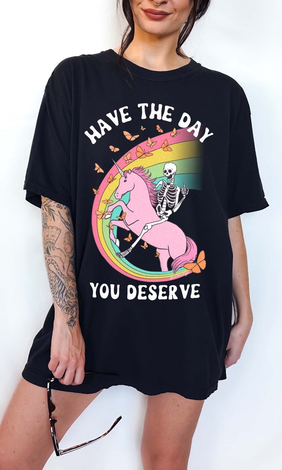 Funny sarcastic t-shirt with unicorn and skeleton design and text saying have the day you deserve