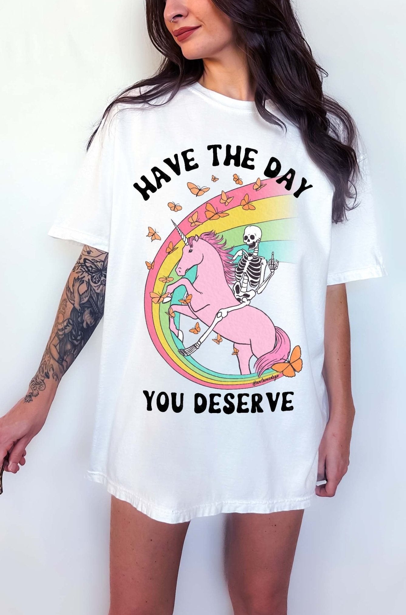 Funny sarcastic t-shirt with unicorn and skeleton design and text saying have the day you deserve