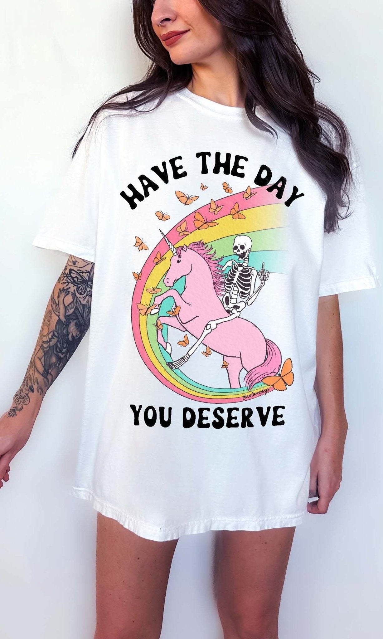 Funny sarcastic t-shirt with unicorn and skeleton design and text saying have the day you deserve