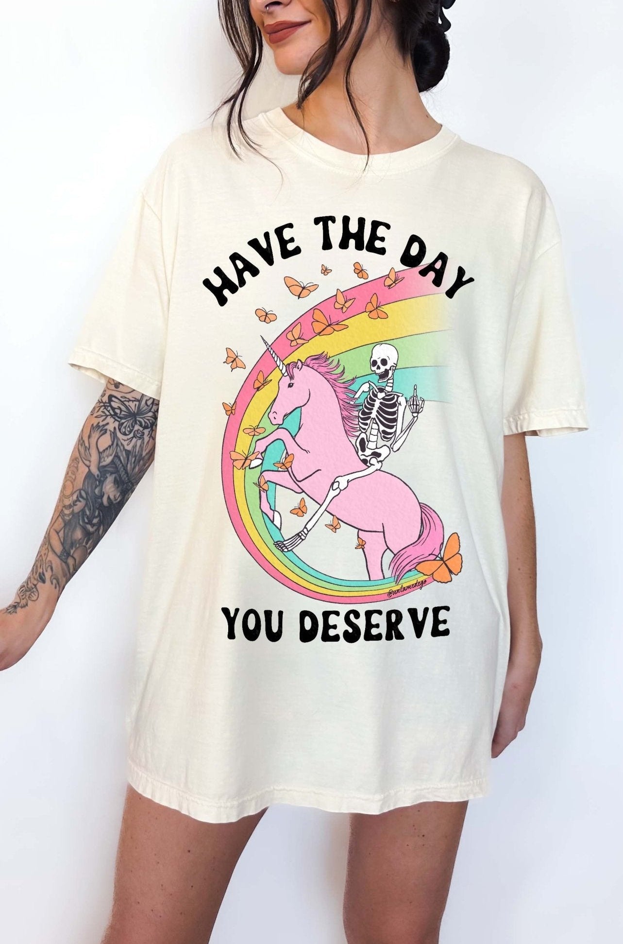 Funny sarcastic t-shirt with unicorn and skeleton design and text saying have the day you deserve