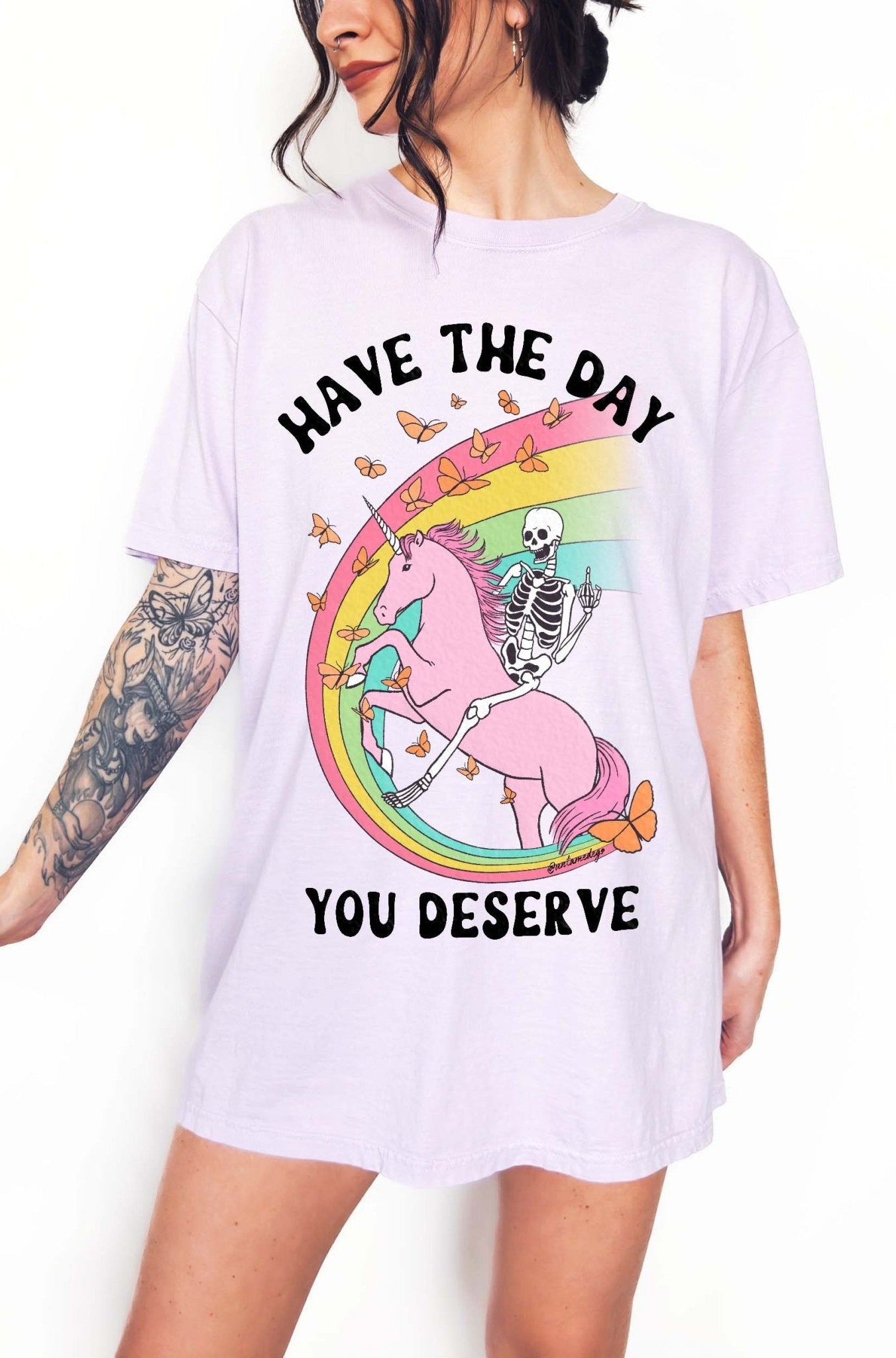 Funny sarcastic t-shirt with unicorn and skeleton design and text saying have the day you deserve