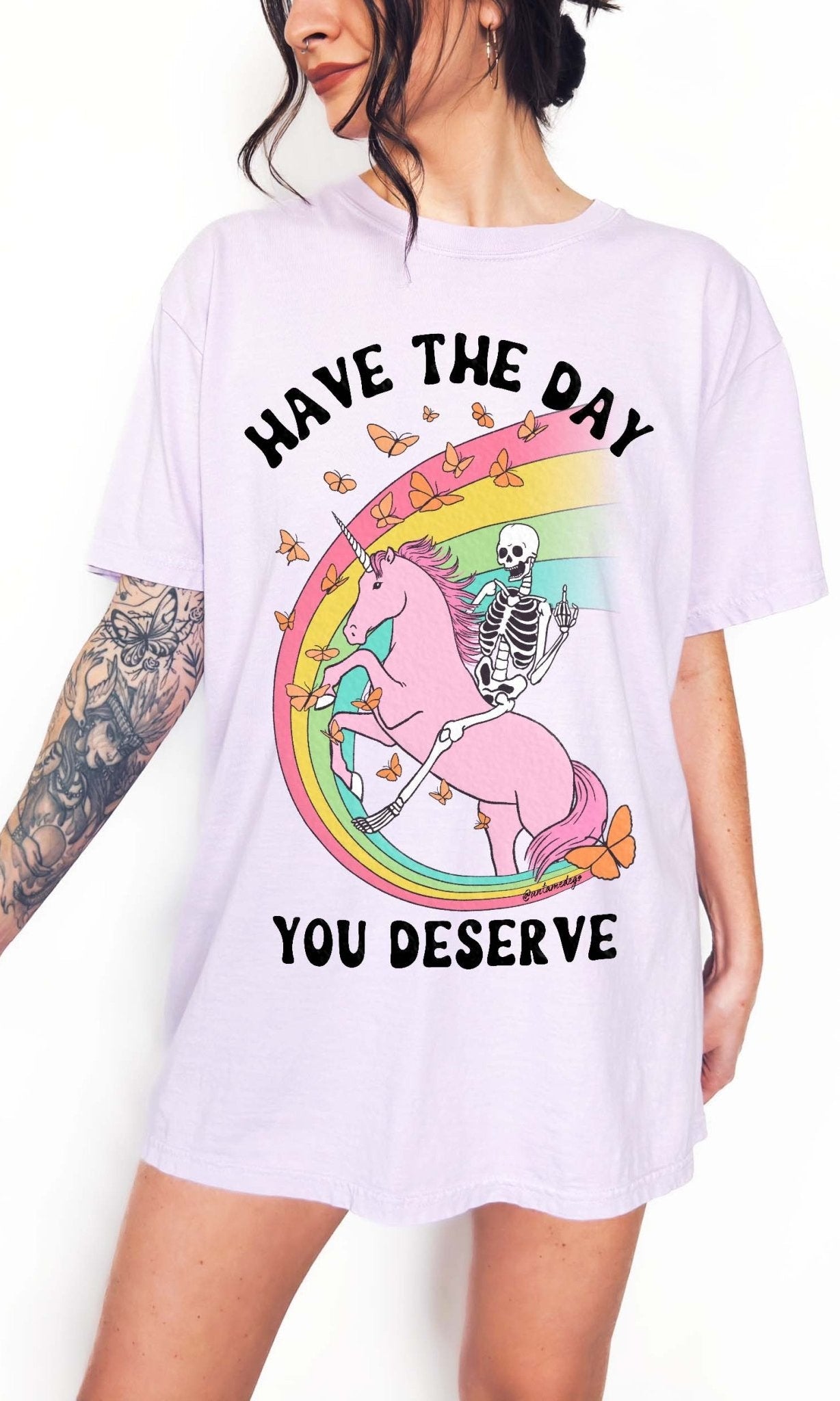 Funny sarcastic t-shirt with unicorn and skeleton design and text saying have the day you deserve