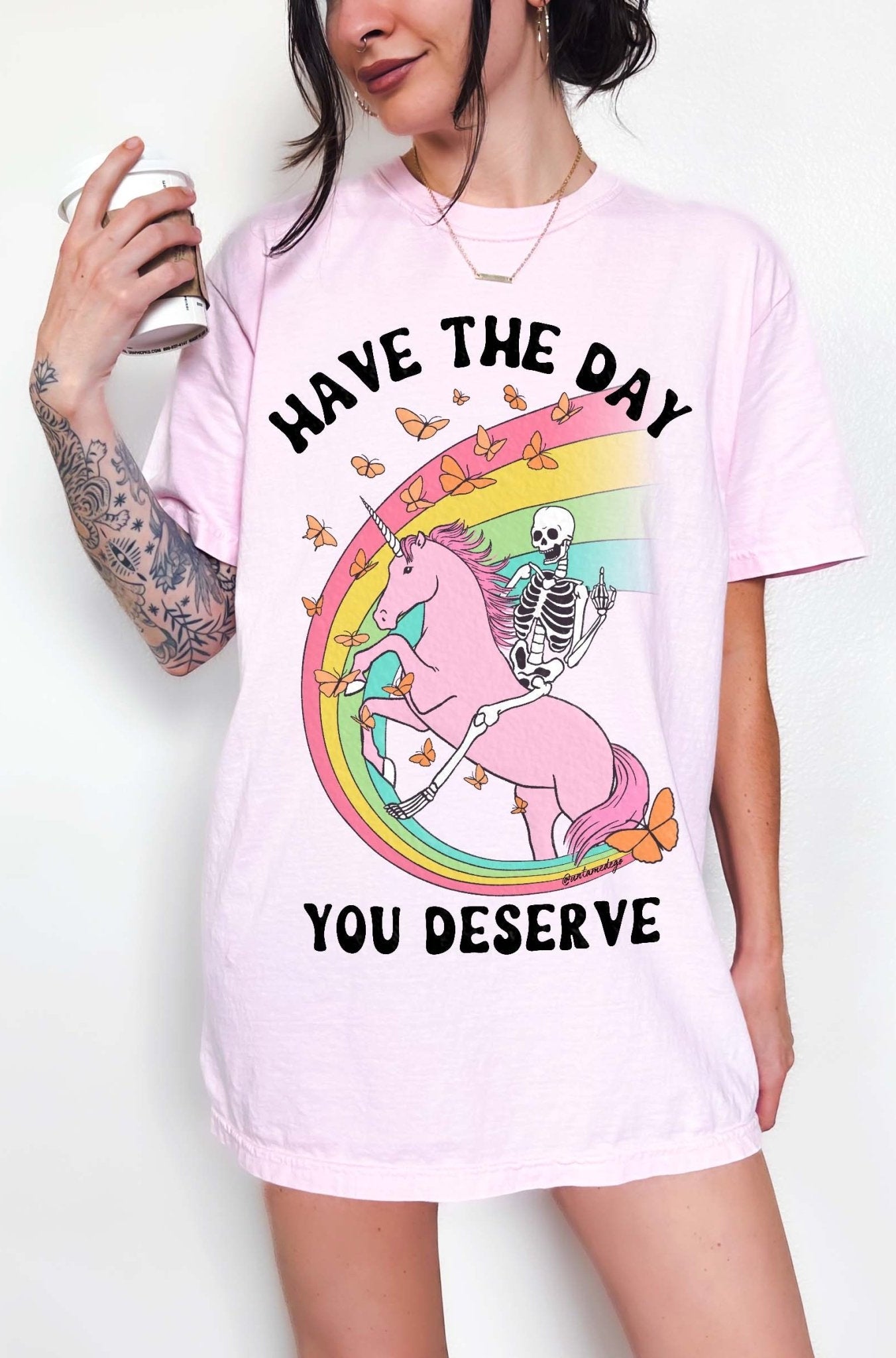 Funny sarcastic t-shirt with unicorn and skeleton design and text saying have the day you deserve