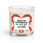 A clear glass jar candle with white wax and a humorous holiday-themed paper label that reads 'BEING MY COWORKER IS the only gift YOU NEED' in black and green text, set against a clean white background.