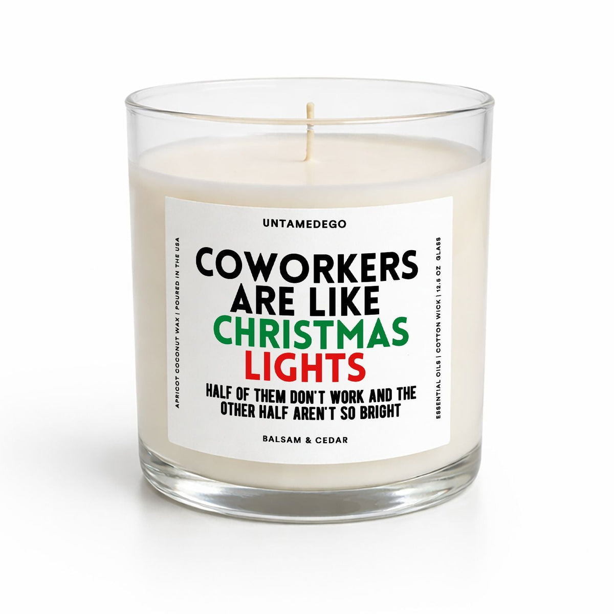 A glass jar candle with cream-colored wax and a white label featuring the text 'COWORKERS ARE LIKE CHRISTMAS LIGHTS' in black, green, and red. The candle is photographed on a clean white background.