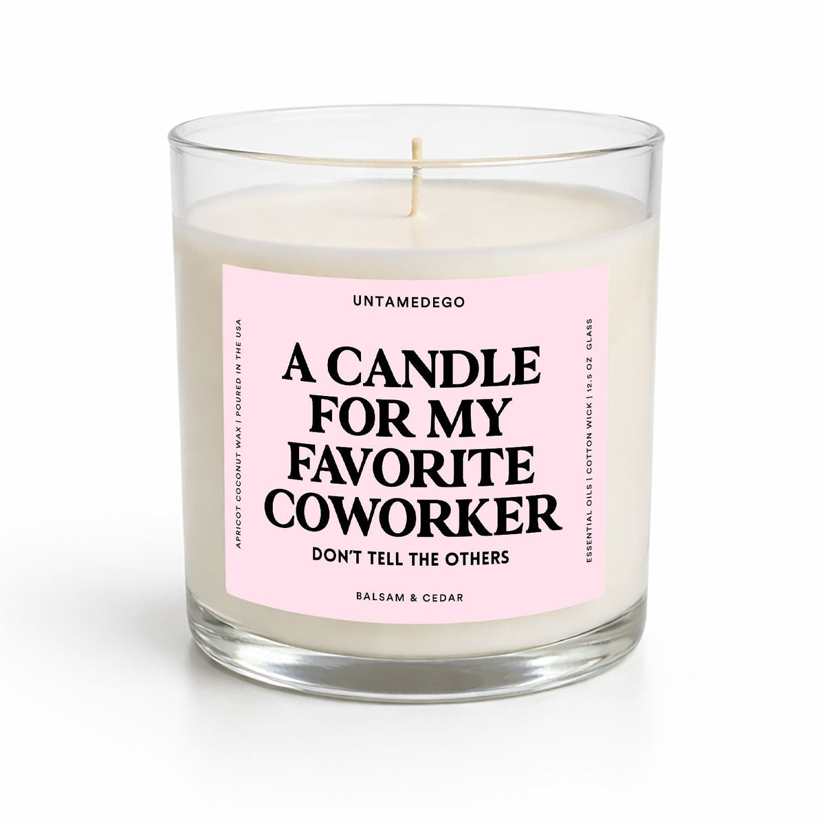 A clear glass jar candle with white wax and a pink label that reads 'A CANDLE FOR MY FAVORITE COWORKER DON'T TELL THE OTHERS' by Untamedgeo.