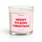 A clear glass jar candle with white wax and a pink label reading 'MERRY FUCKING CHRISTMAS' in red text, shown on a clean white background.