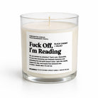 A 12 oz coconut apricot candle in a clear glass jar with a white label that reads 'Fuck Off, I'm Reading'.