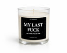 A white soy wax candle in a clear glass jar with a black square label that reads 'MY LAST FUCK OH LOOK IT'S ON FIRE' and smaller text 'UNTAMEDEGO' and 'COASTAL AMBER | CEDAR'.