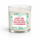 A clear glass jar candle with white wax and a humorous holiday label that reads 'LIGHT ME IF YOU FEEL LIKE DECKING A COWORKER' in red text, shown on a clean white background.