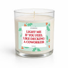 A clear glass jar candle with white wax and a humorous holiday label that reads 'LIGHT ME IF YOU FEEL LIKE DECKING A COWORKER' in red text, shown on a clean white background.