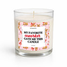 A clear glass jar candle with white wax and a single wick, featuring a pink label with cartoon characters and the text 'MY FAVORITE coworker GAVE ME THIS CANDLE' on a white background.